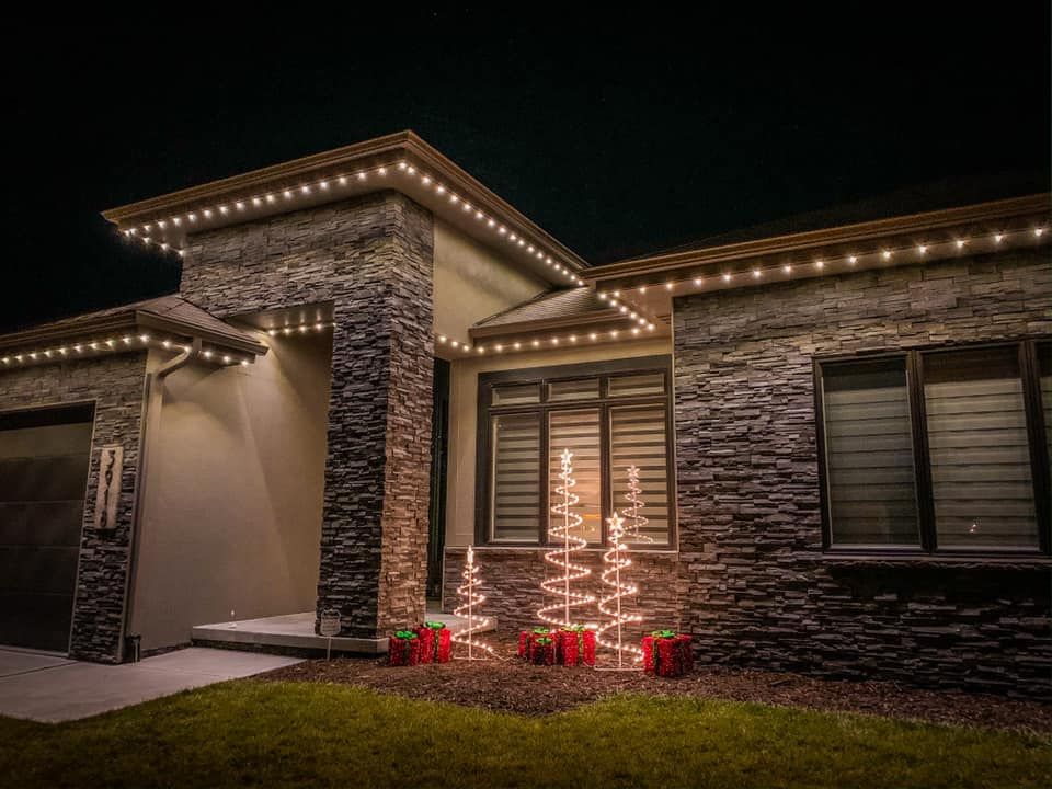 Warm white accent lighting on stone home