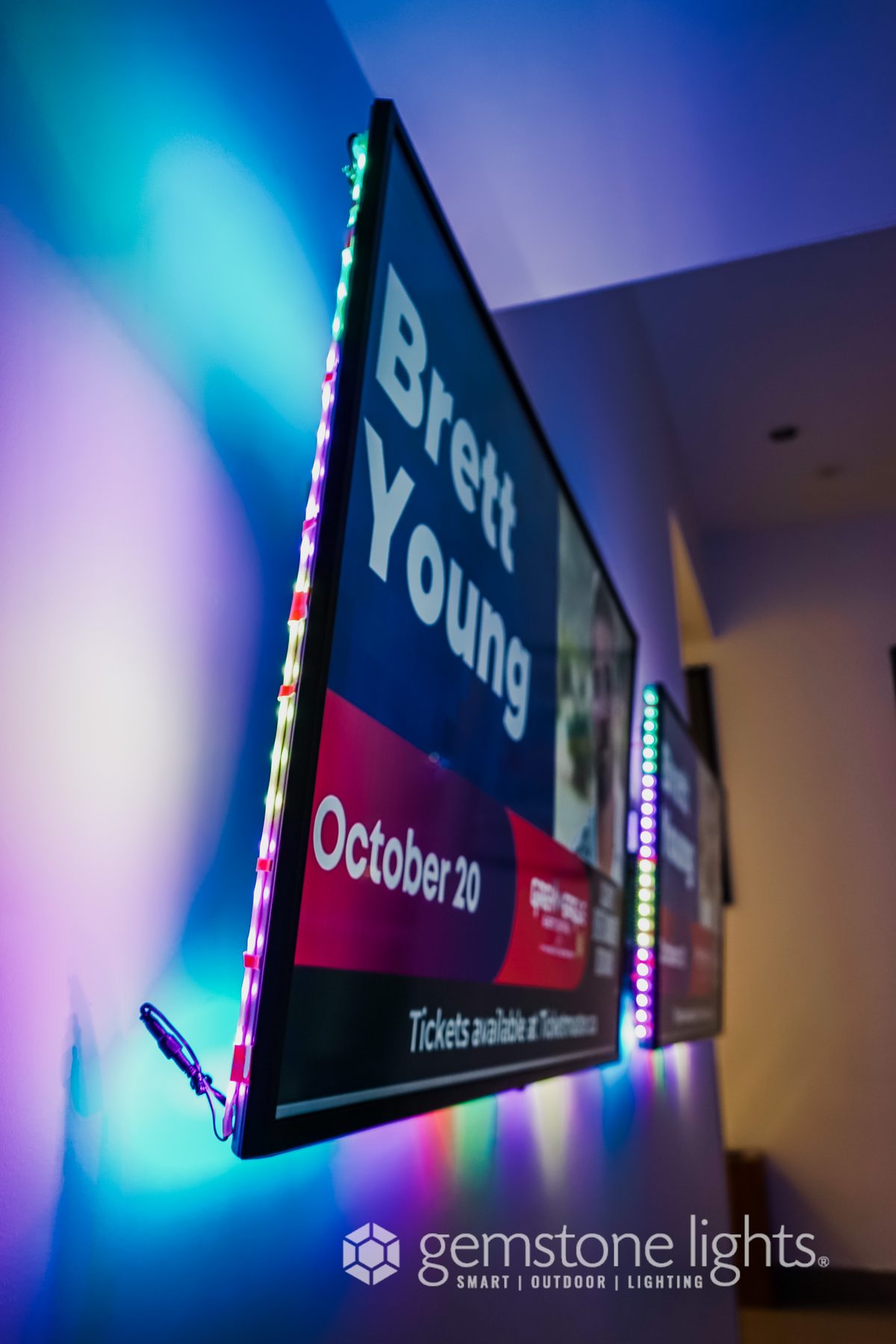 RGB LED strip lighting behind wall-mounted TV and signage