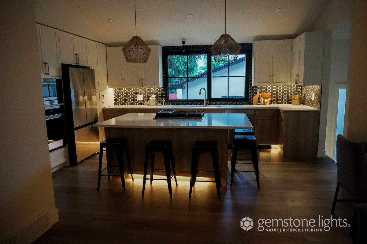 Warm white LED strip lighting under kitchen island and cabinets